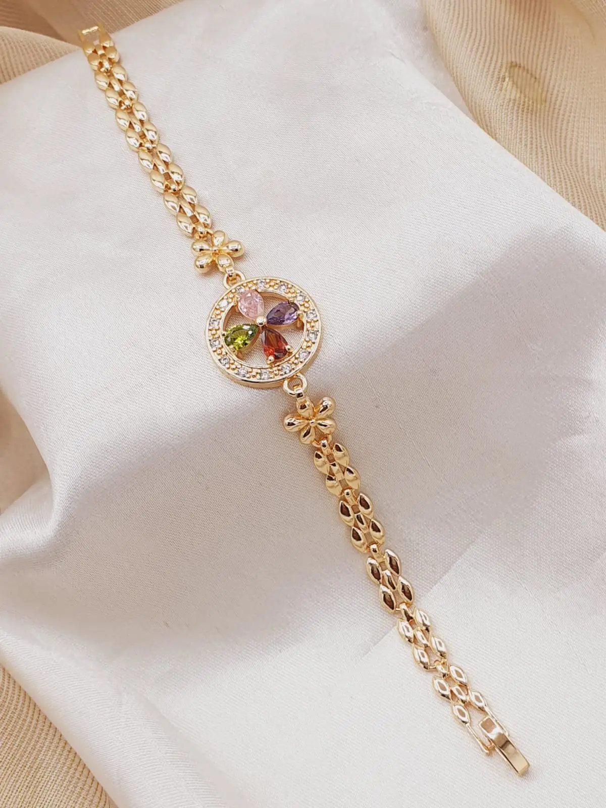Fancy bracelet in gold color with multi color stones